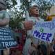 Large inflated figures of Sheriff Joe Arpaio (L) and President Trump are seen above ant-Trump protesters outside the Phoenix Convention Center at a rally by President Donald Trump on August 22, 2017 in Phoenix, Arizona